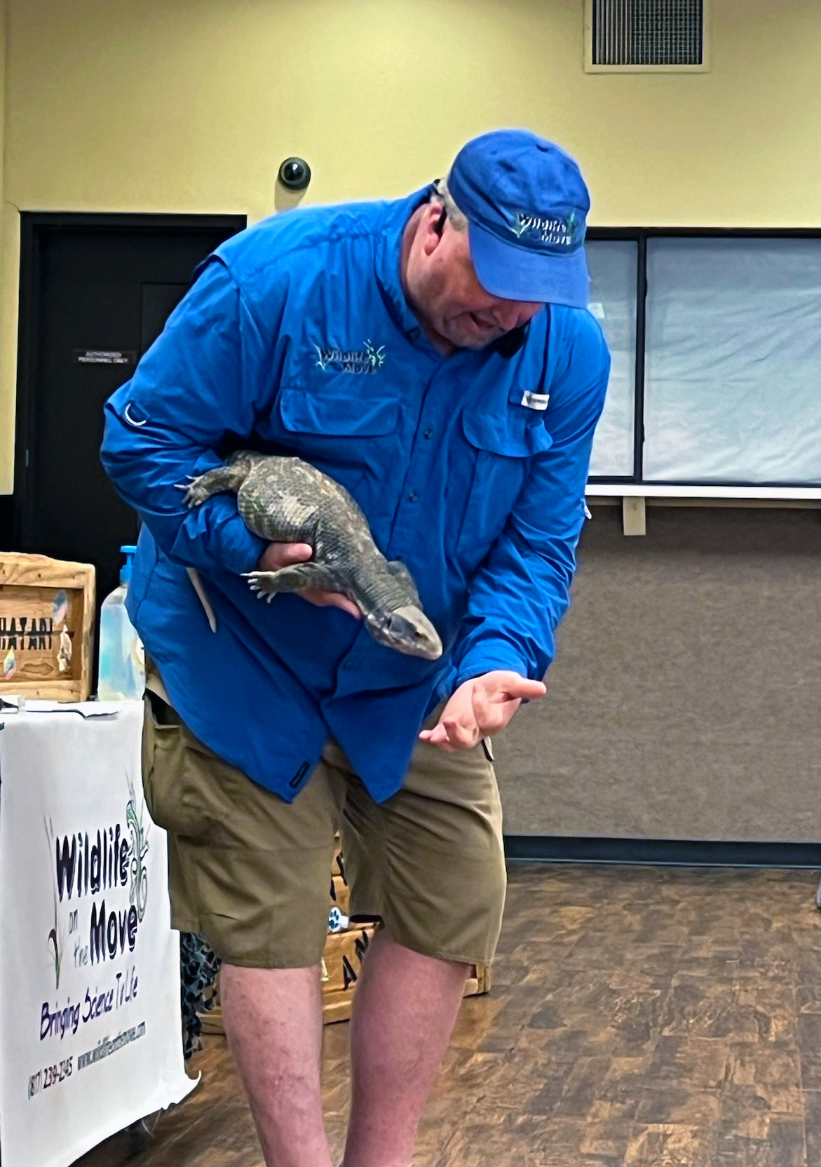 Presenter holding an iguana